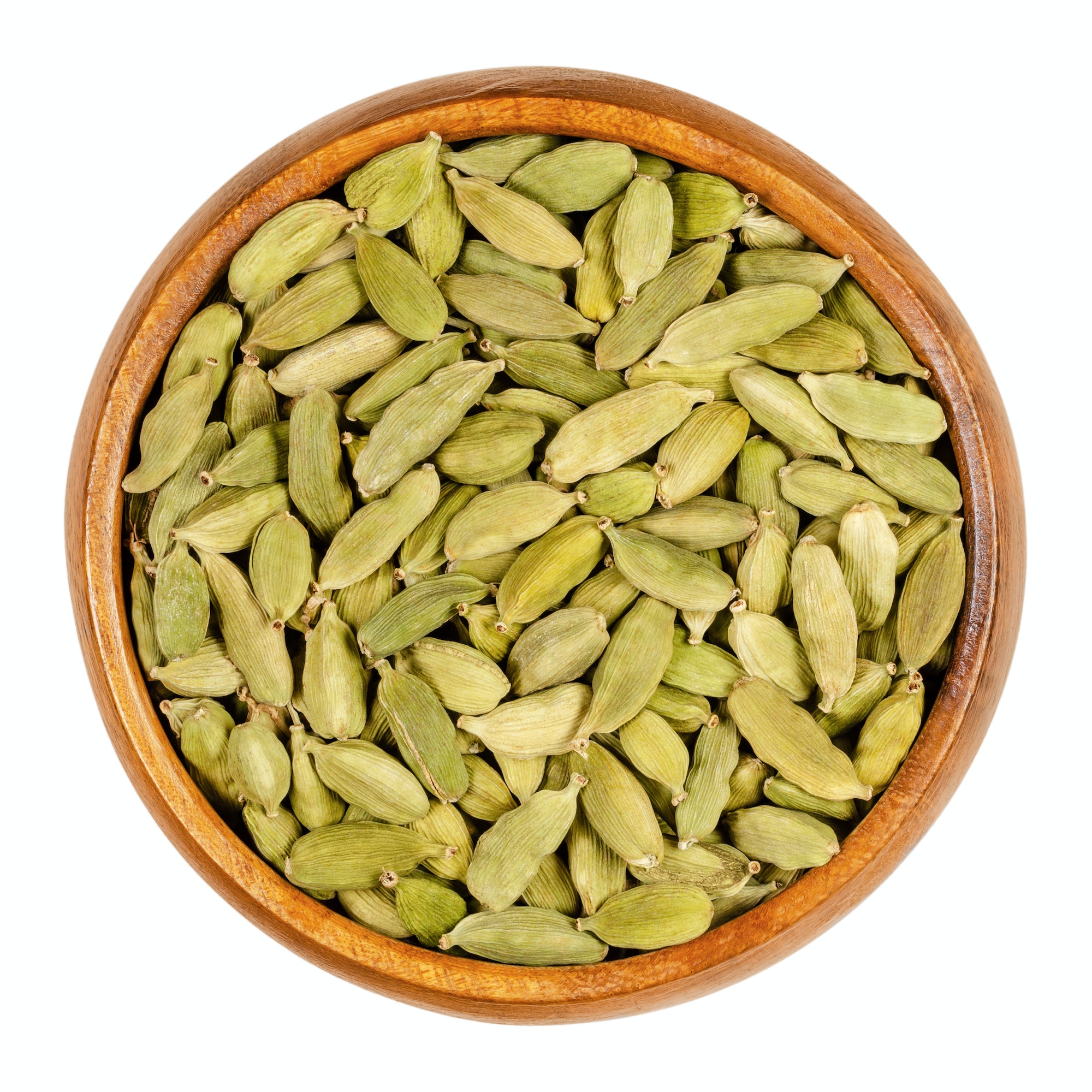 Green cardamom pods, processed true cardamom seeds, in a wooden bowl